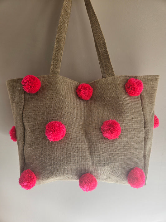 Sac en jute artisanal avec pompons colorés et fermeture à clip